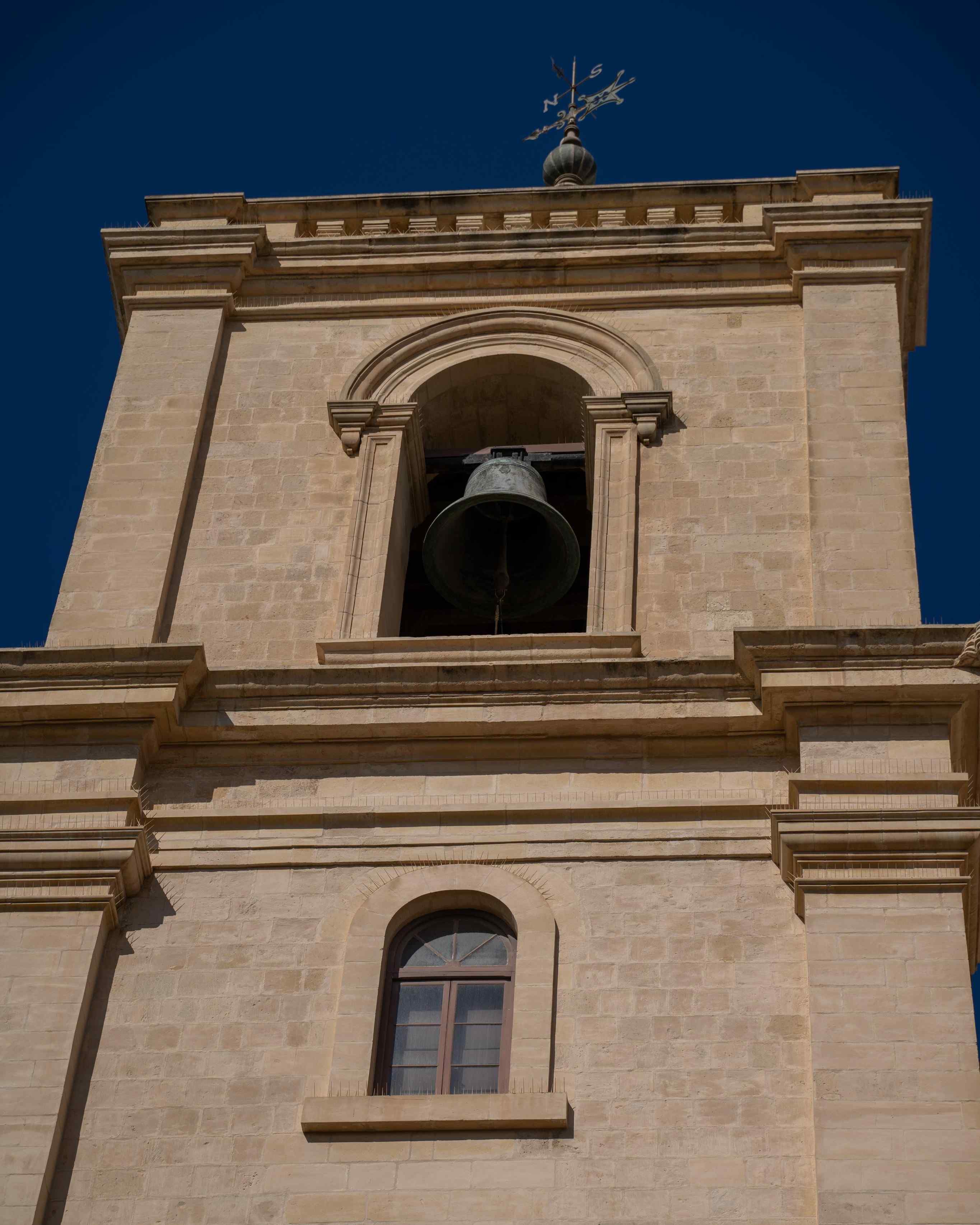 facade of a church and a bell