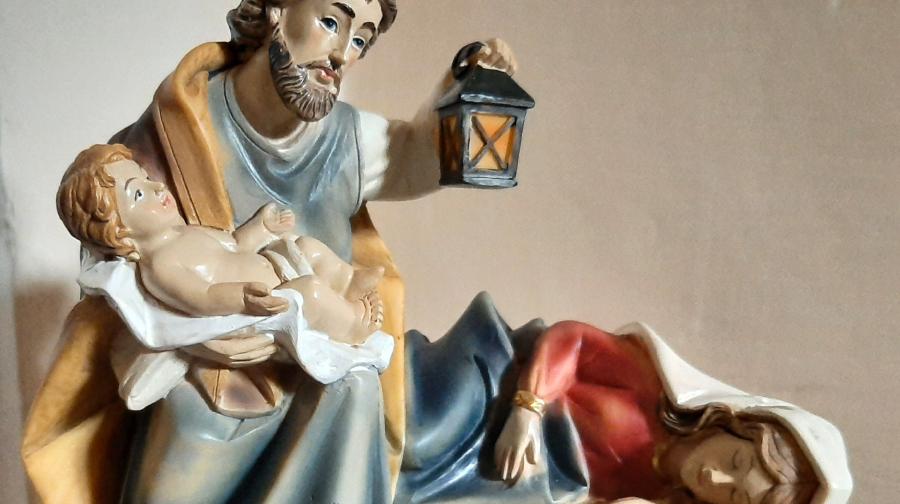 Crib with St Joseph caring for the baby