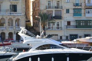 A yacht parked with Birgu Waterfront in the background