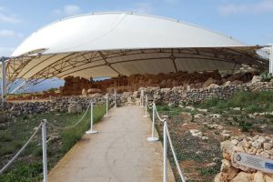 A road up to a cluster of old Maltese temples under a protective cover